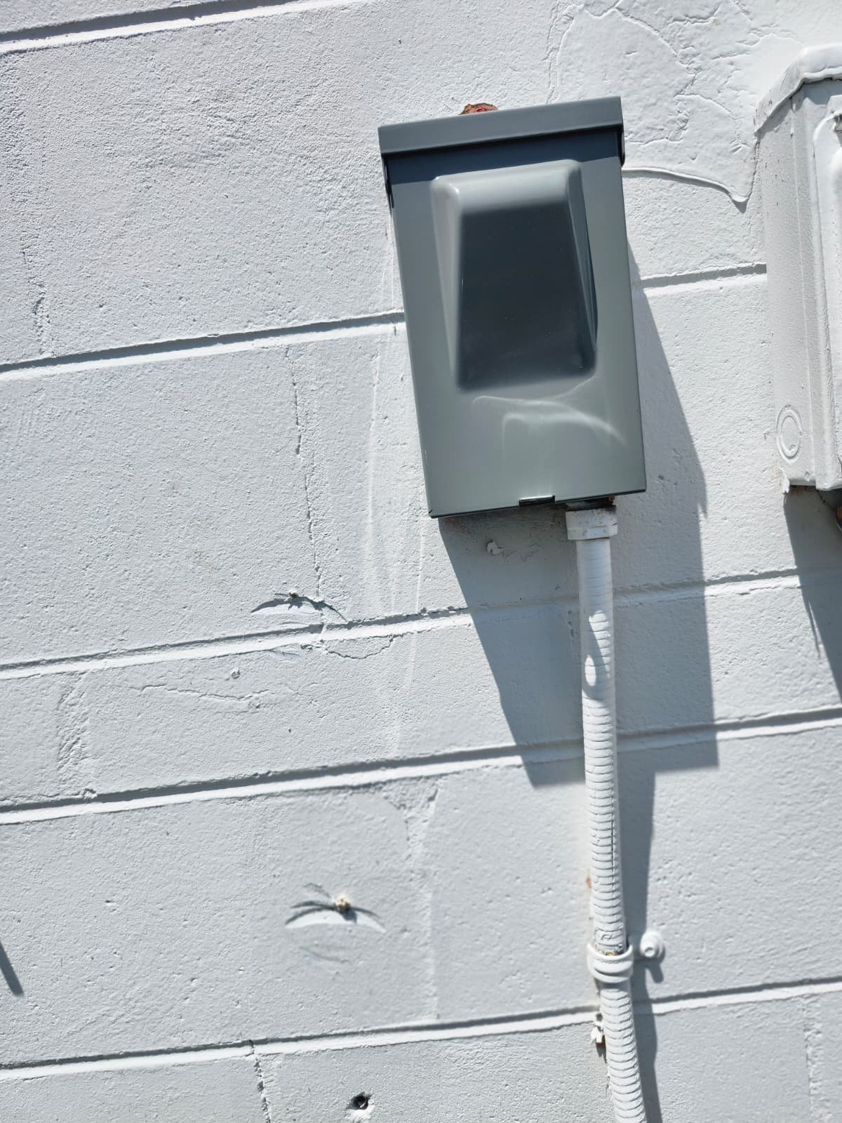 Exterior view of a disconnect switch mounted on a wall in St. Petersburg, FL 33712.