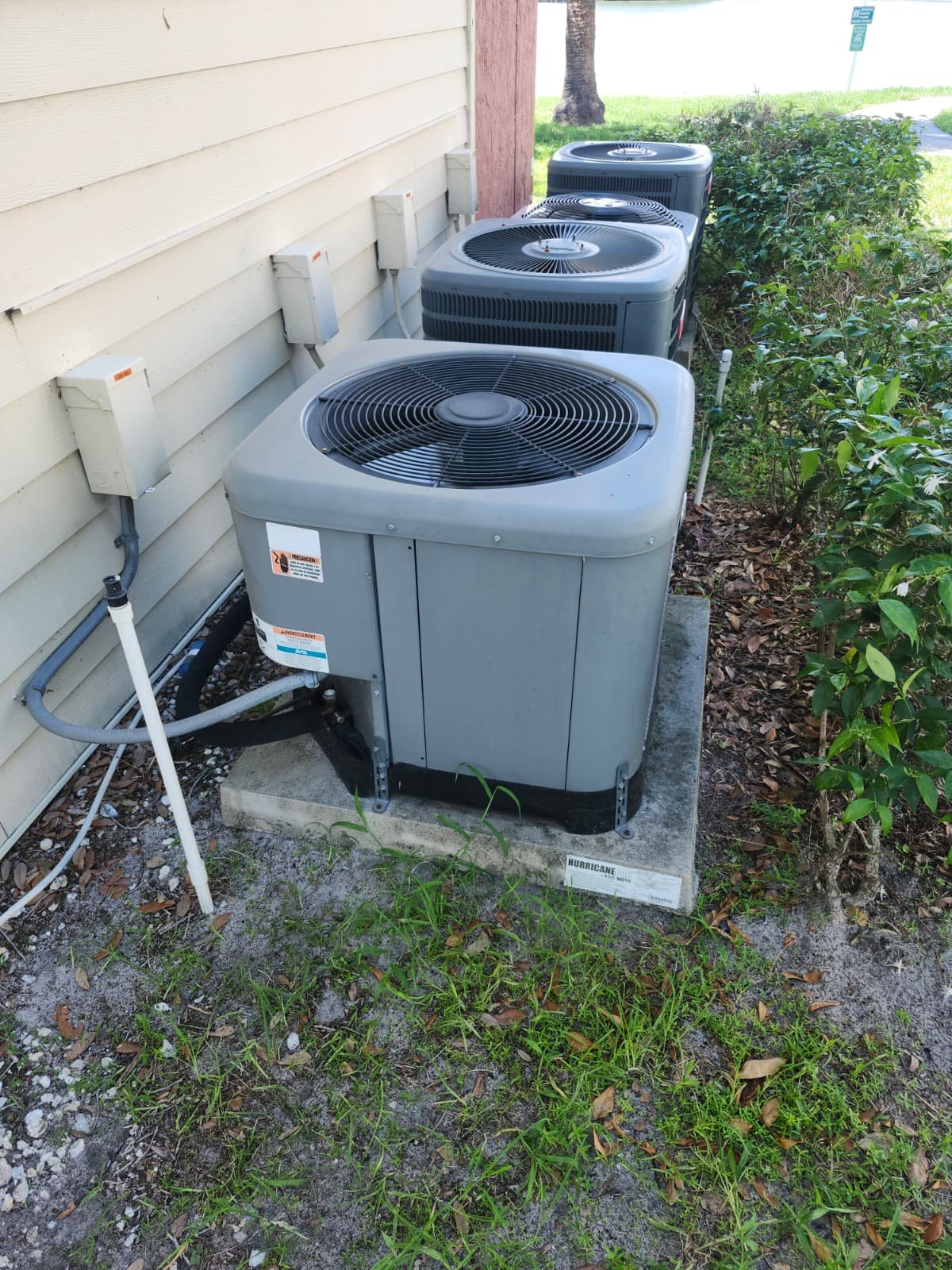 Multiple outdoor AC units installed beside house in Brandon, FL 33511. Efficient cooling system.