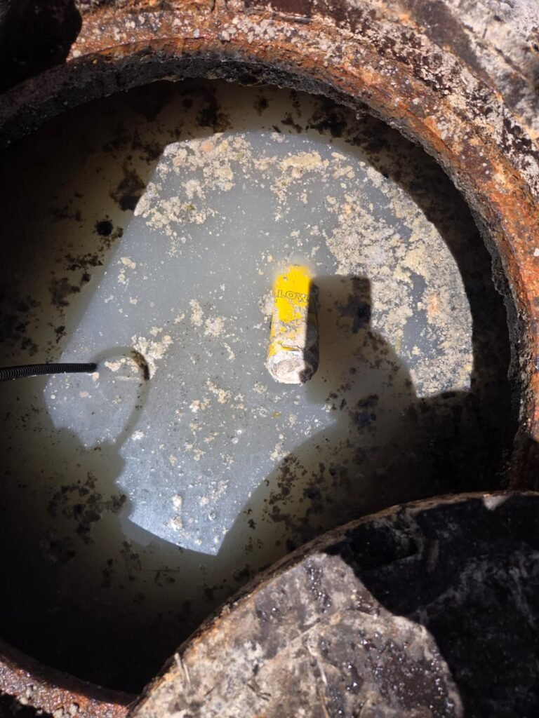 An opened sewer line with standing water and debris in St. Petersburg, FL 33701.