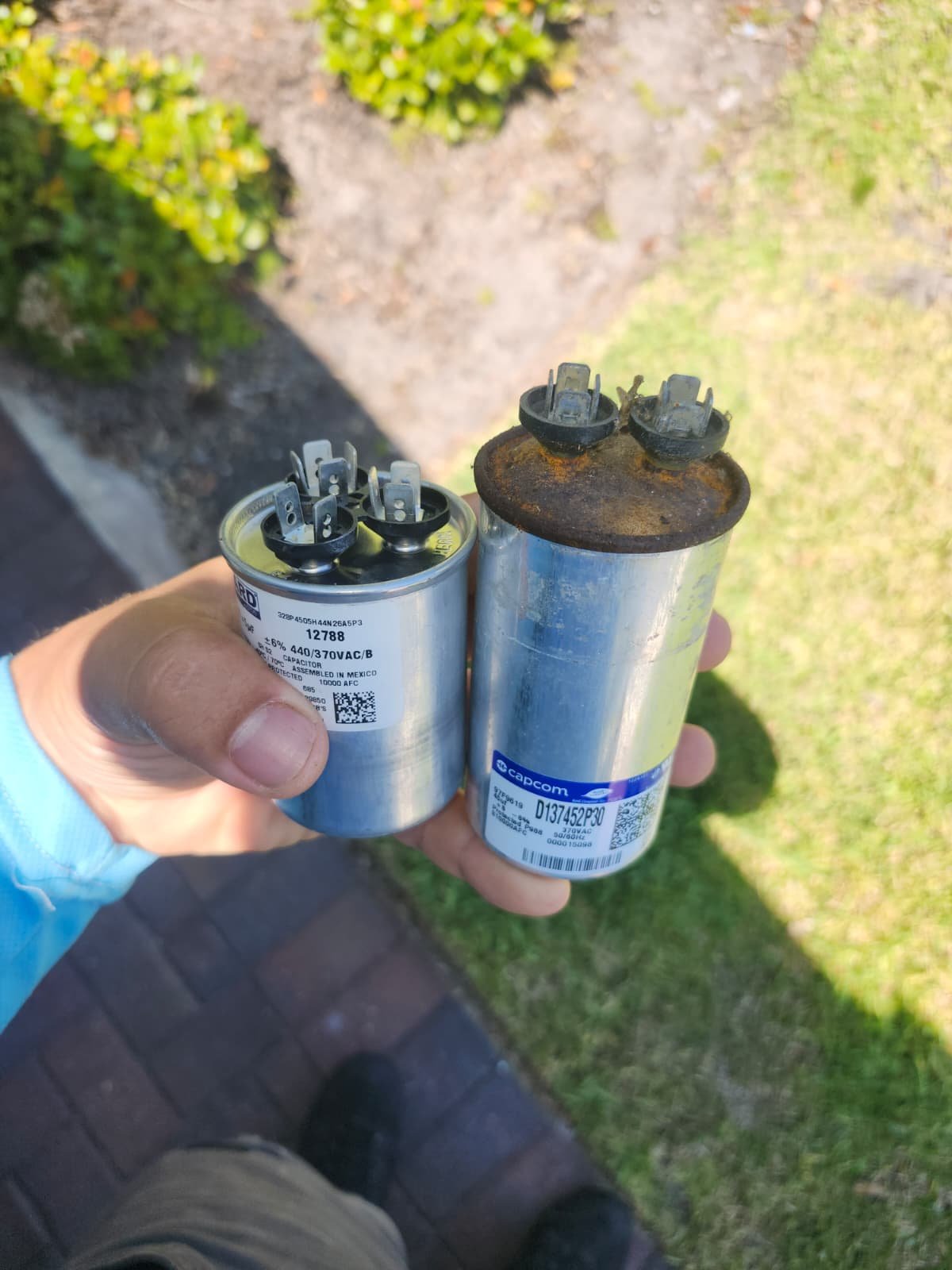 New vs Old Capacitor in Parrish, FL 34219 Comparison of new and old capacitors held in hand in Parrish, FL 34219.