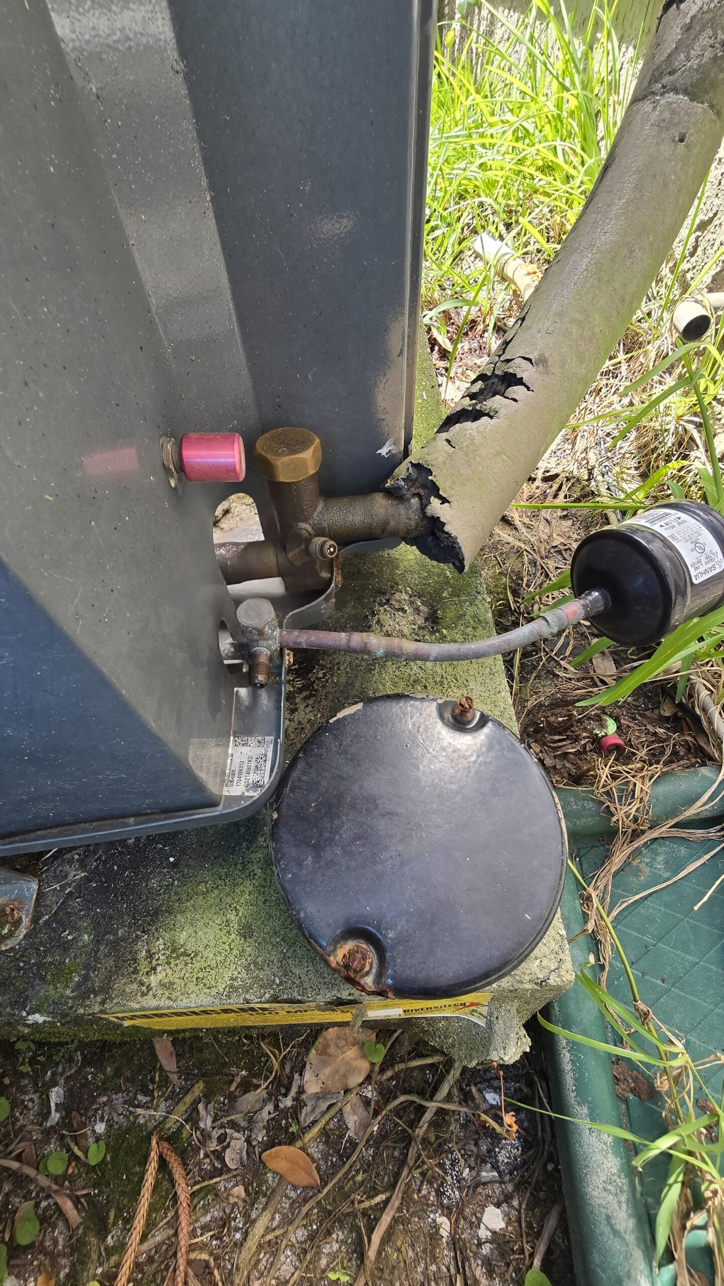 Outdoor AC unit with visible wear and connections, Oldsmar, FL 34677.