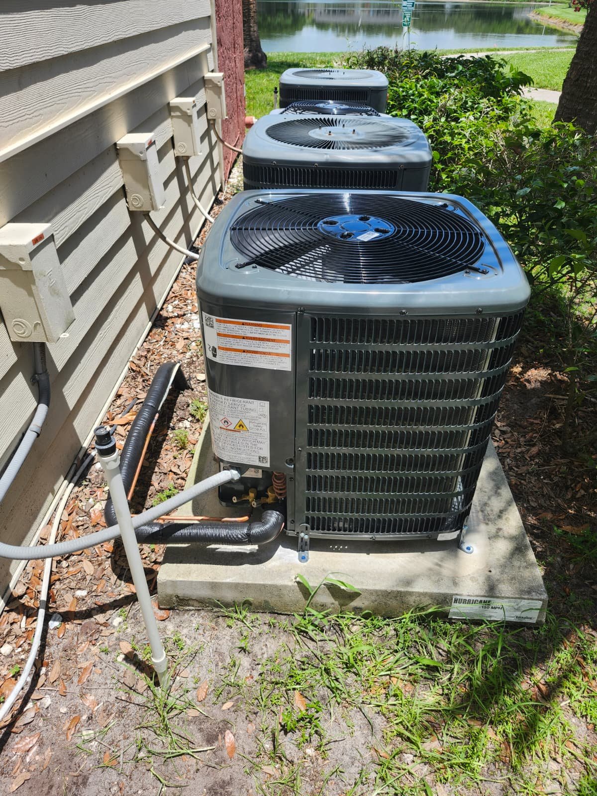 Outdoor AC units beside a house with clear view in Brandon, FL 33511. Reliable cooling.