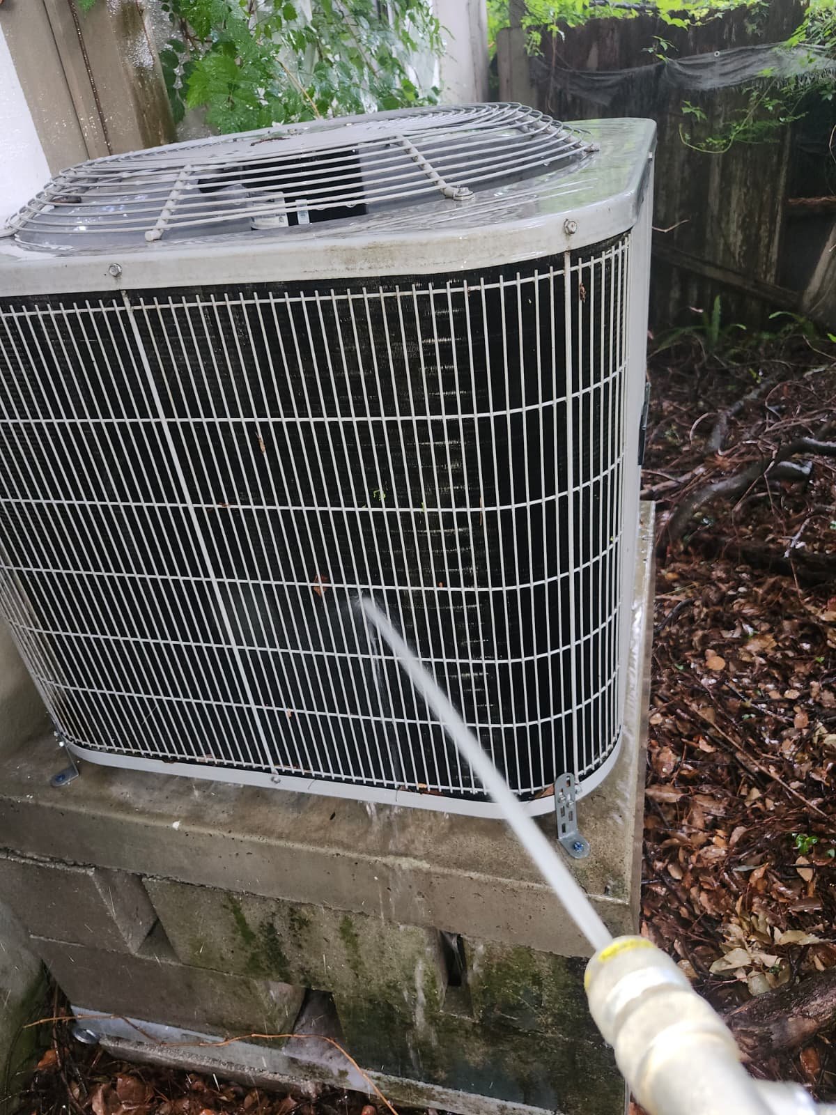 Outdoor AC Water Spray - Tampa, FL 33604 Cleaning outdoor AC unit with water spray at 1300 Alicia Avenue, Tampa, FL 33604.