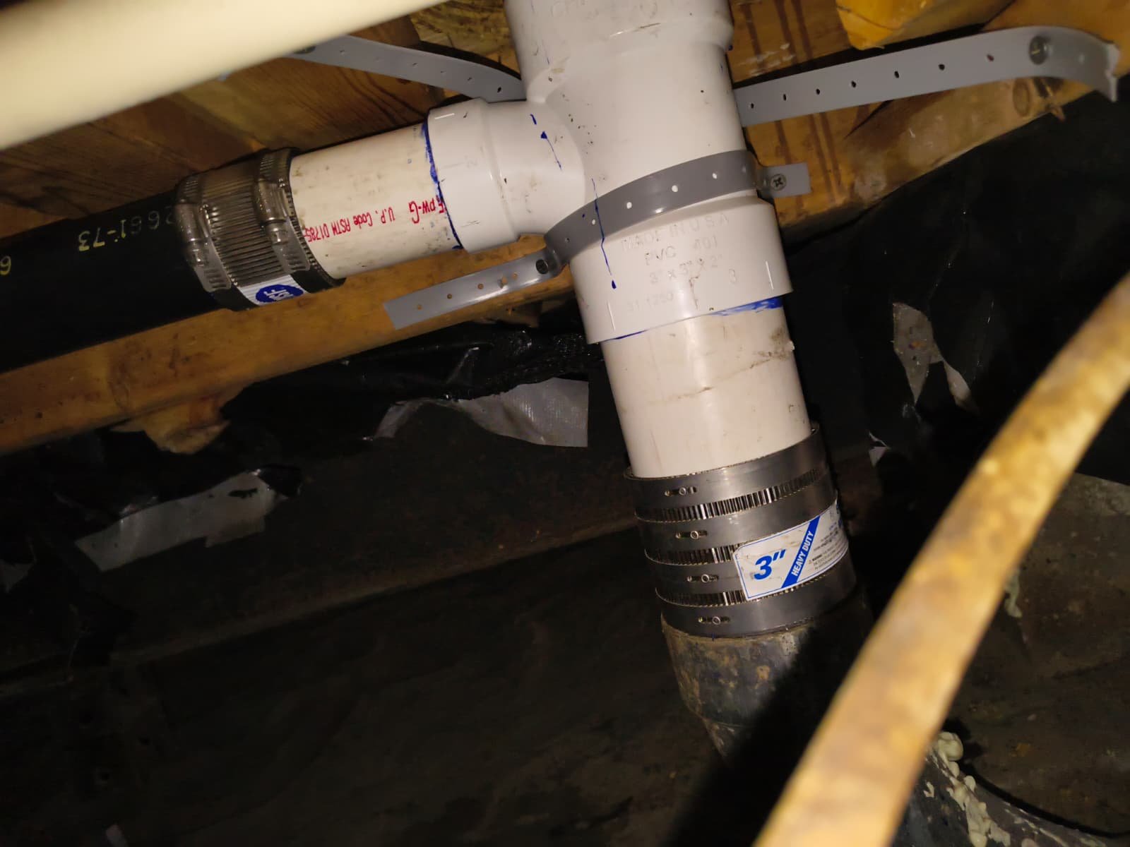 PVC piping and connectors under the floor in Palm Harbor, FL 34684 during sanitary tee replacement.