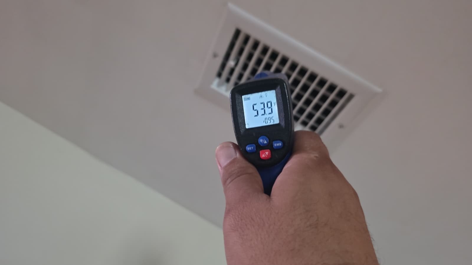 Temperature gun at ceiling vent during AC service in St. Petersburg, FL 33703.