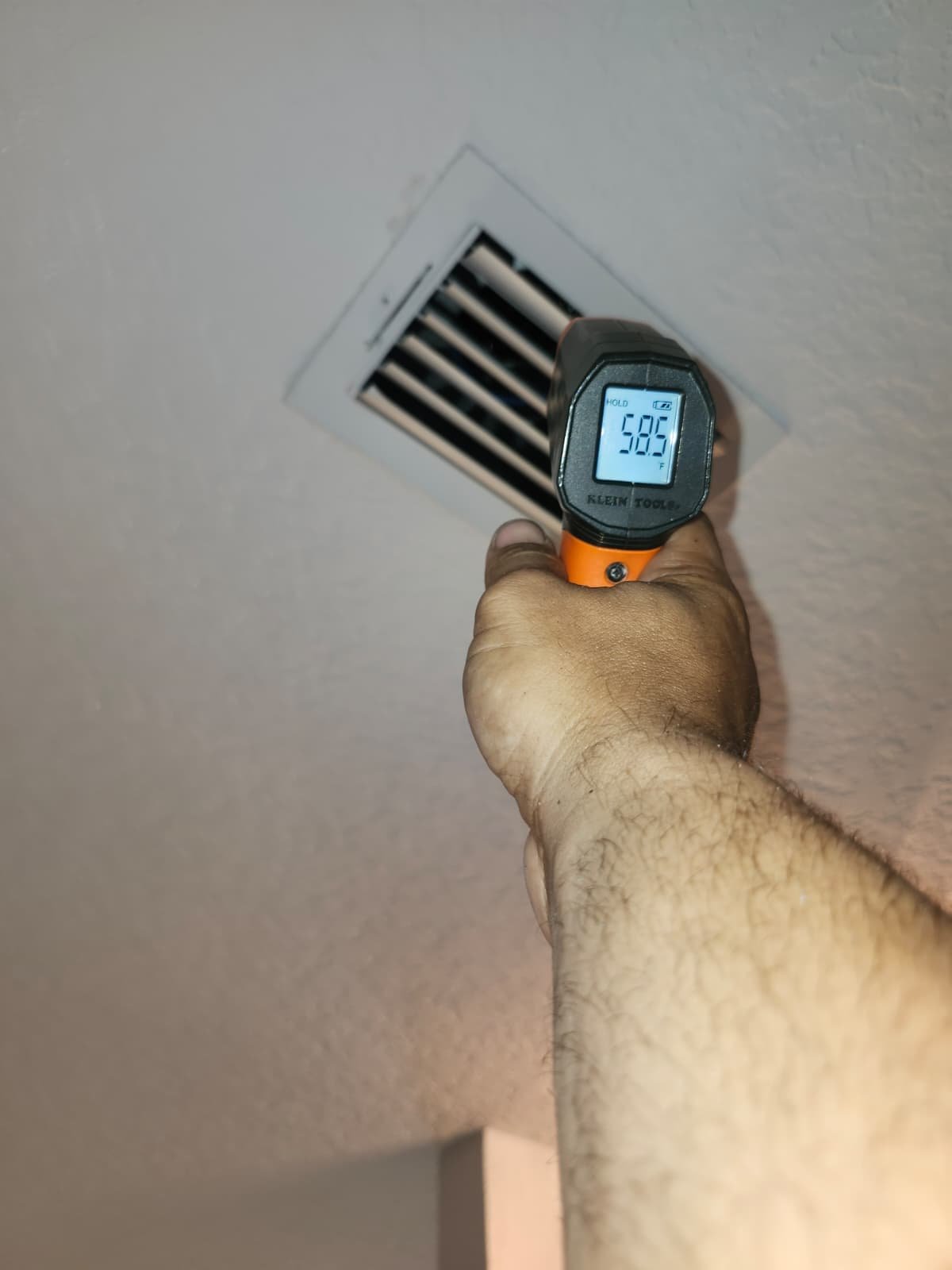Measuring air vent output with temperature gun, Tampa, FL 33647.