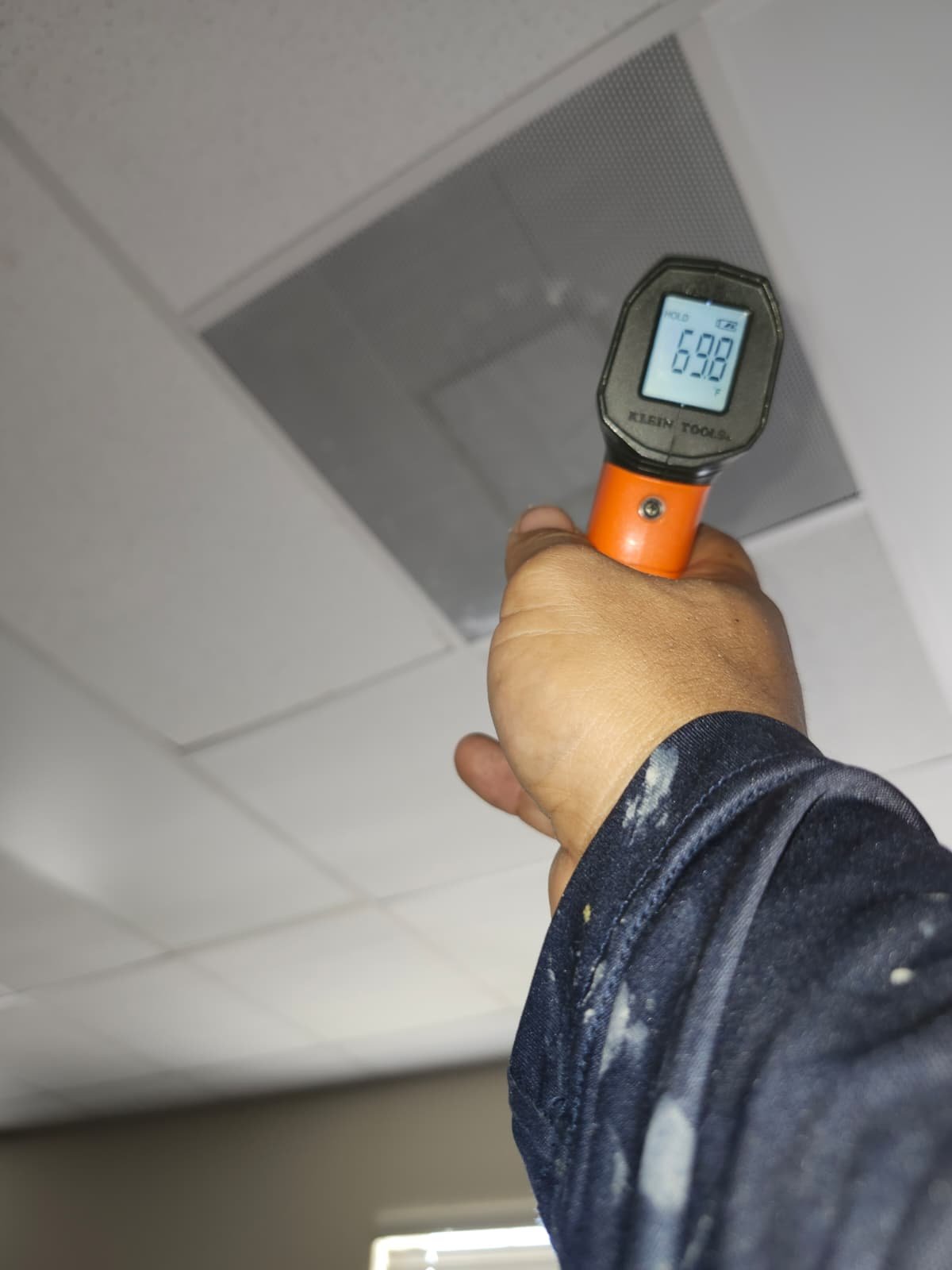 Person using a temperature gun to measure air vent output, New Port Richey, FL 34655.