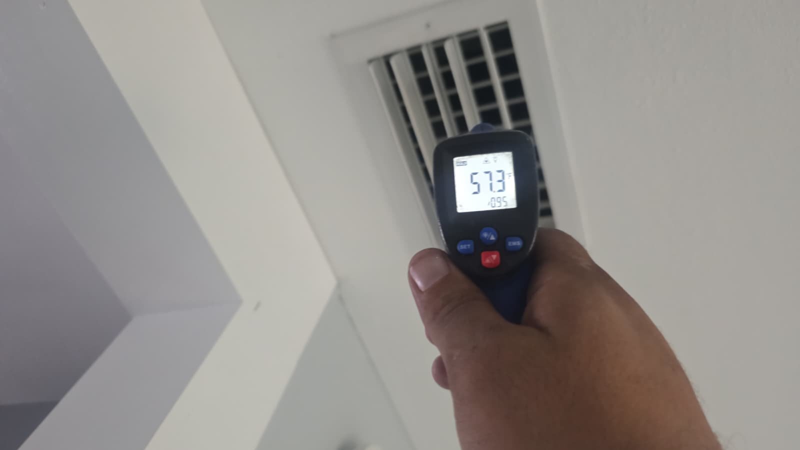Infrared thermometer reading near ceiling vent in St. Petersburg, FL 33710.