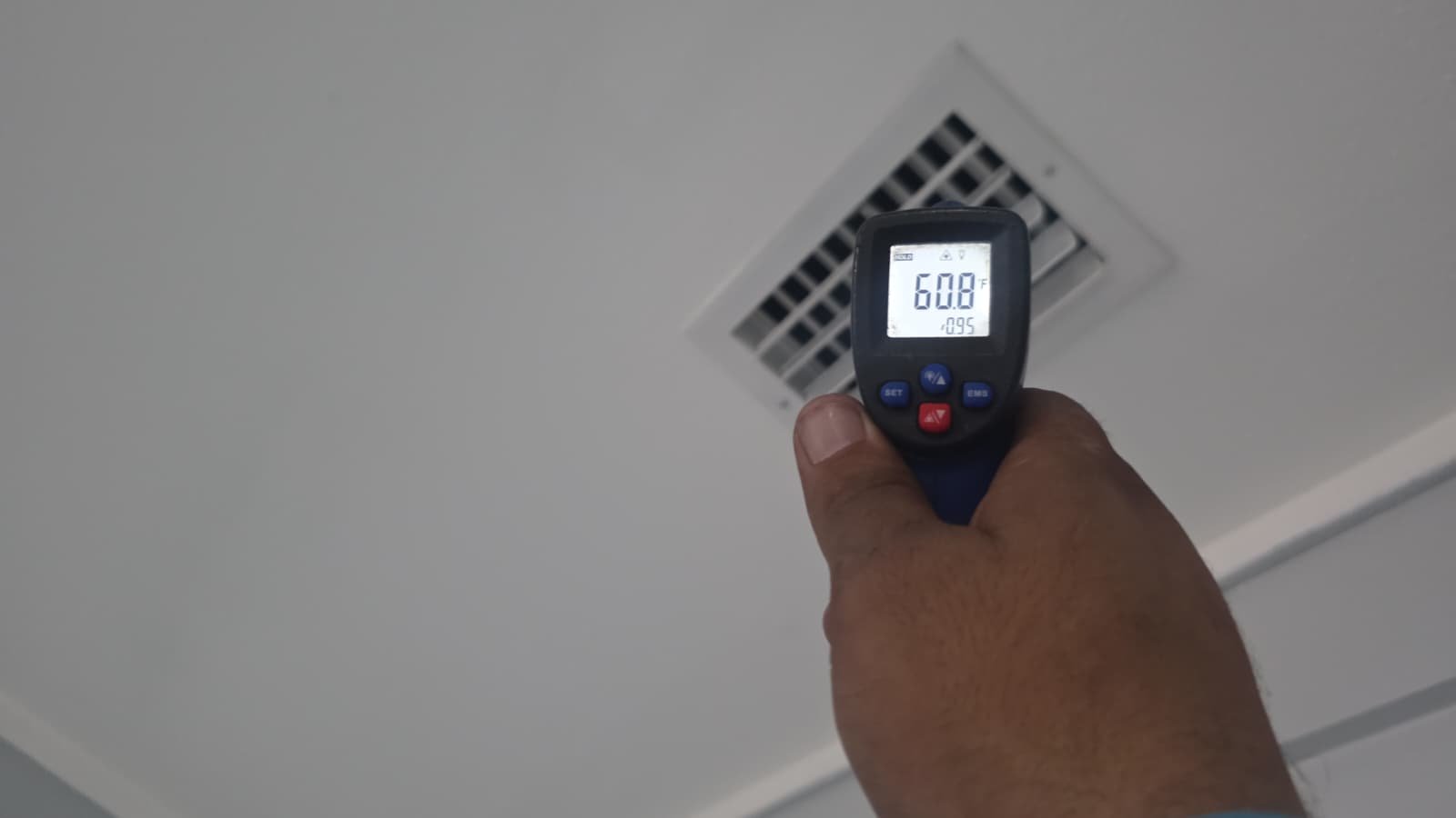 Infrared thermometer reading near ceiling vent in St. Petersburg, FL 33710.