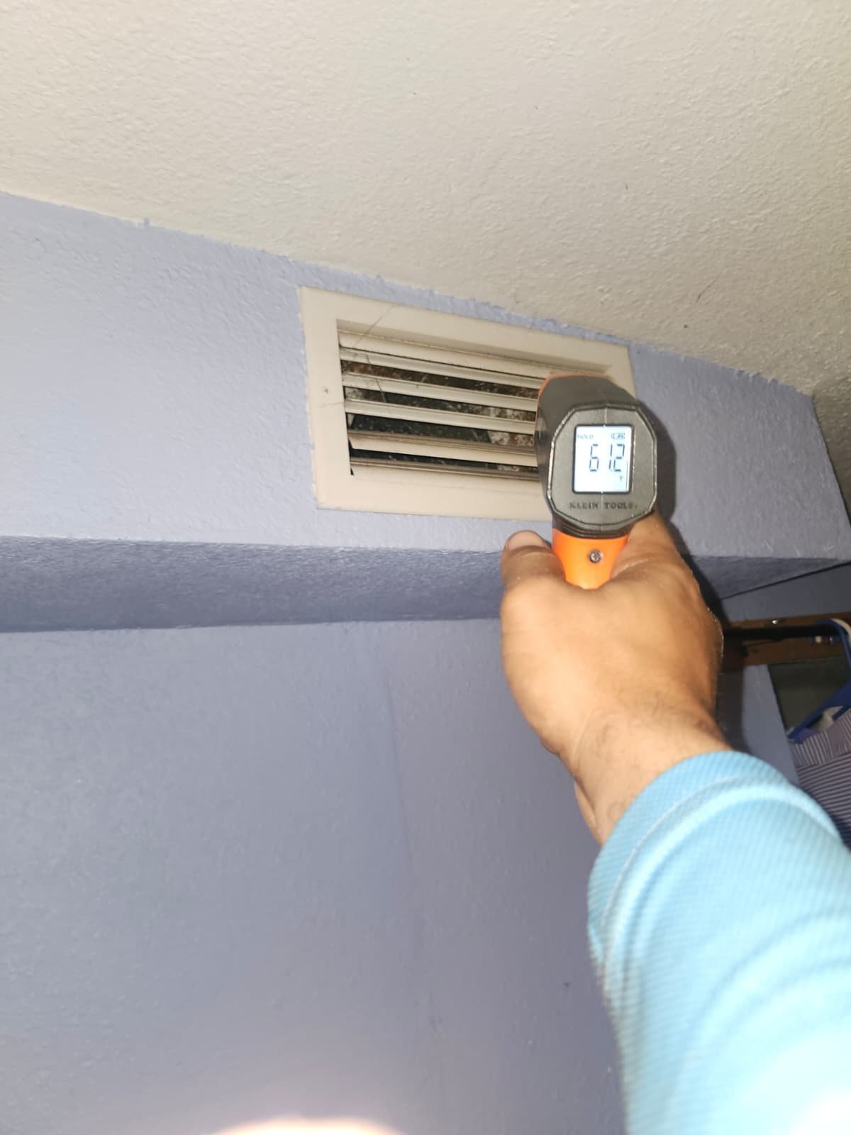 Thermometer reading at air vent during system check in Tampa, FL 33604.