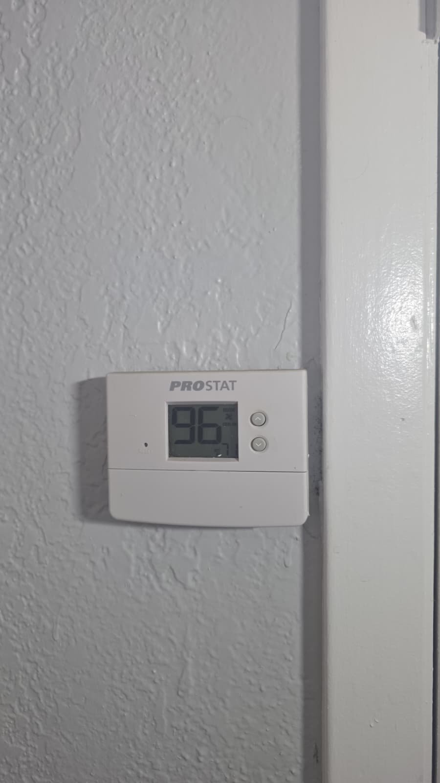 Wall-mounted thermostat displaying temperature in Tampa, FL 33611.