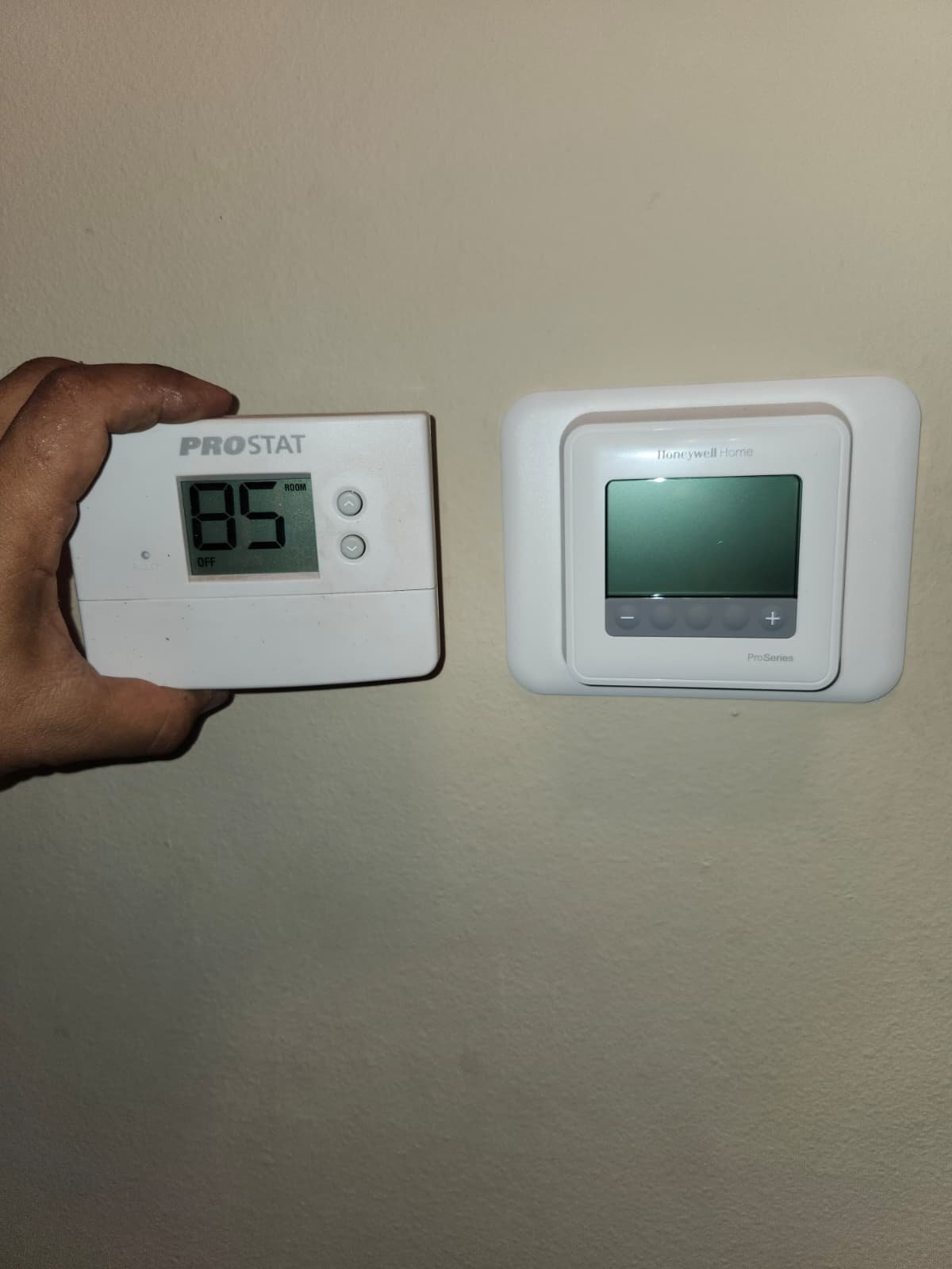 Comparison of old Prostat and new Honeywell Home thermostats in Lutz, FL 33559. Upgrade in progress.