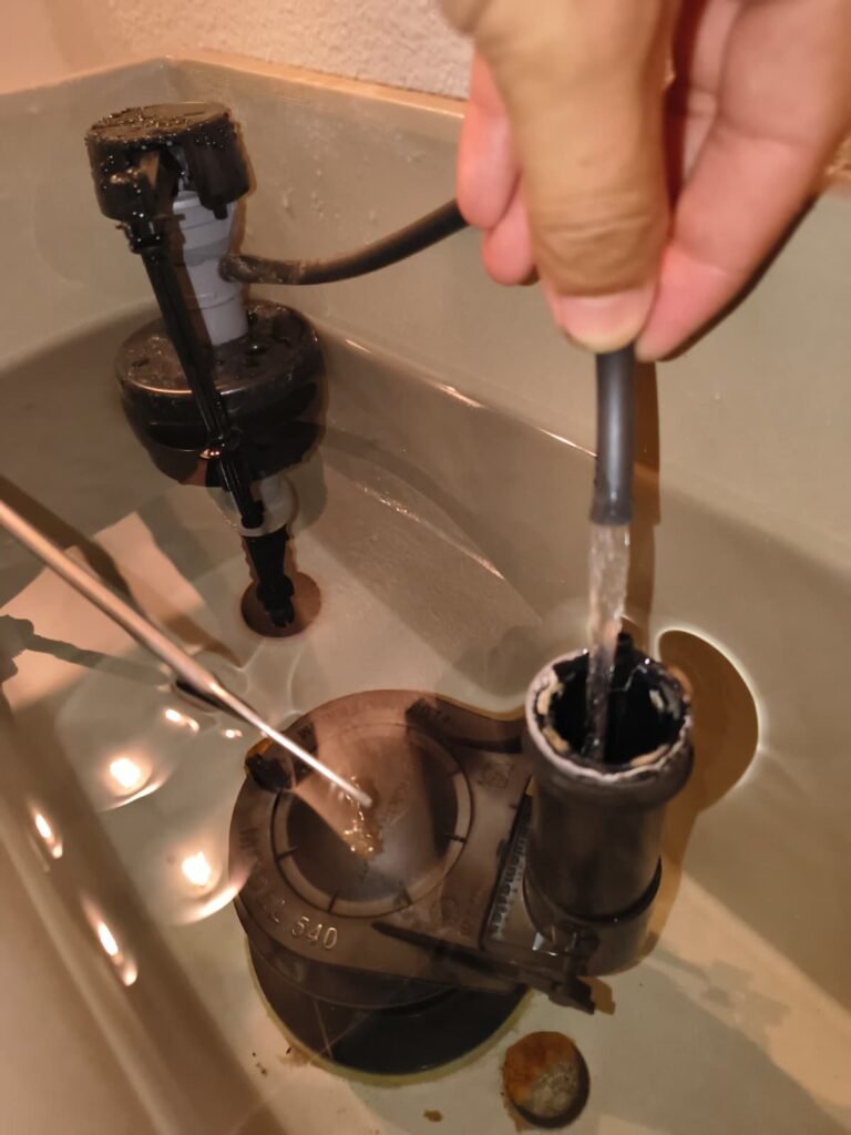 Working on a toilet fill valve inside the tank in Brandon, FL 33511.
