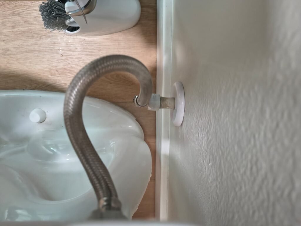 A braided supply line feeding a toilet in Tampa, FL 33626.