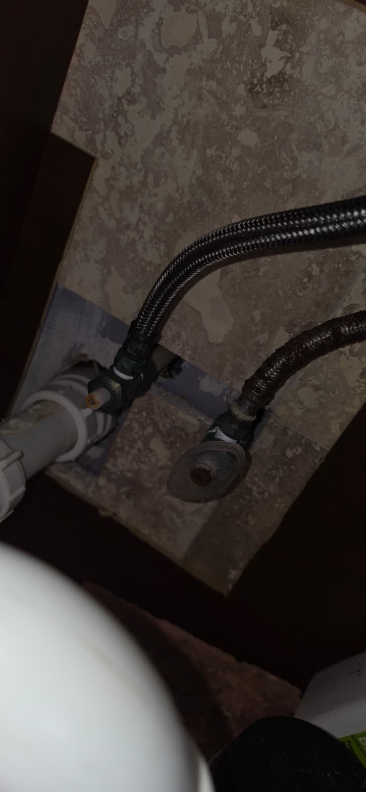 Under-Sink Plumbing Connections - Tampa, FL 33624 Close-up of under-sink plumbing connections in Tampa, FL 33624. Braided line focus.