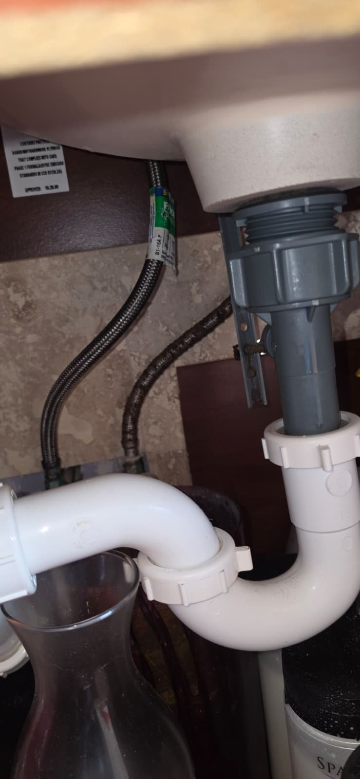 Under-Sink Plumbing View - Tampa, FL 33624 Under-sink plumbing with braided supply lines in Tampa, FL 33624. Ongoing work.