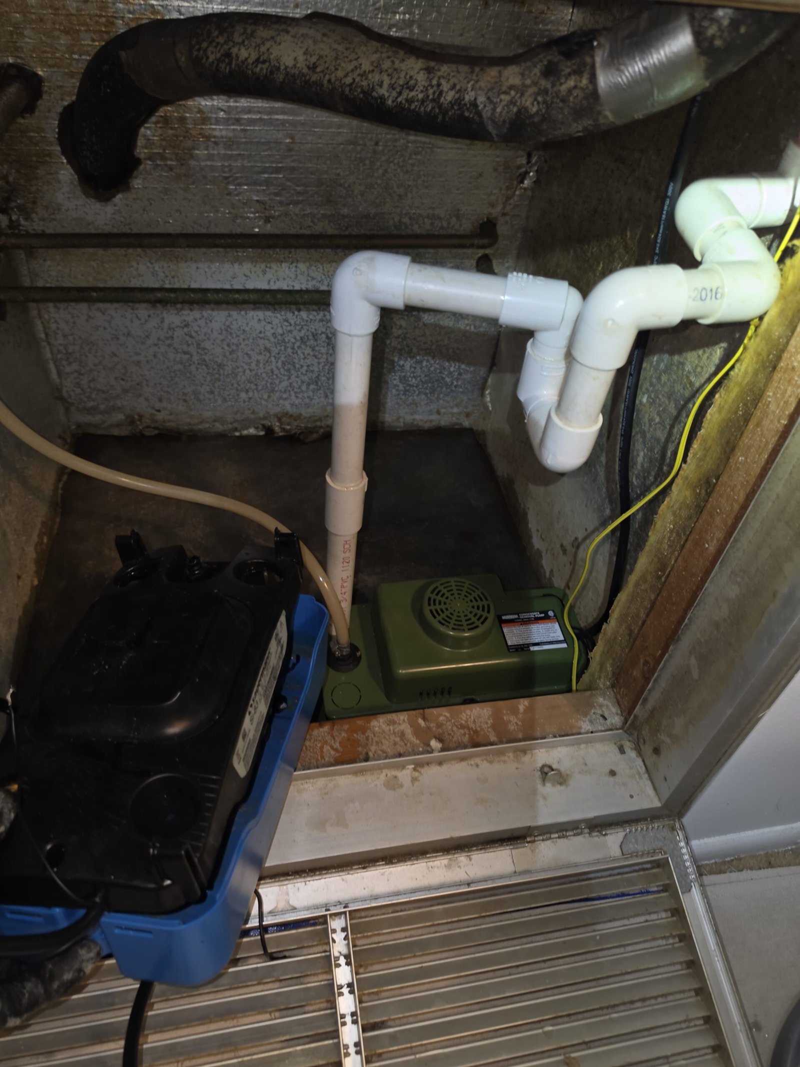 Condensate pump setup in utility area with equipment in Hudson, FL 34667.
