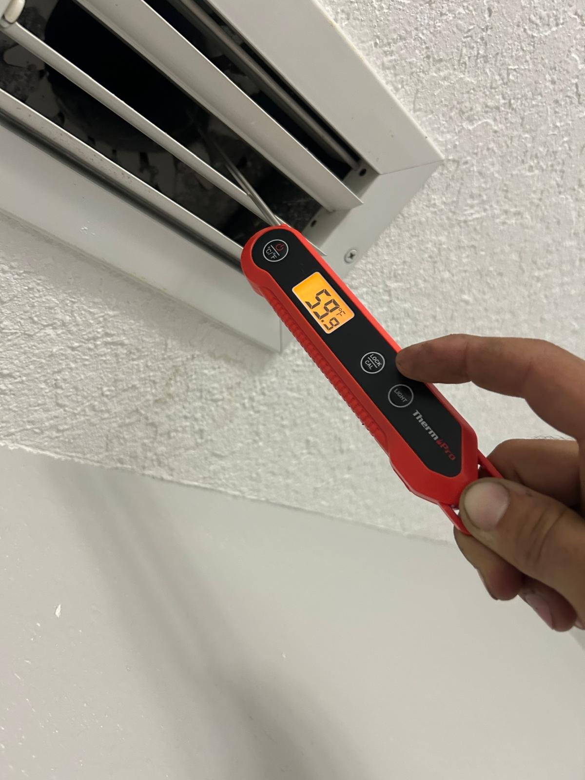Thermometer reading temperature at a vent, Oldsmar, FL 34677.