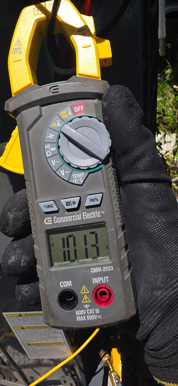 In-Progress Disconnect Switch Work in Tampa, FL 33611 Technician using a multimeter for voltage reading during disconnect switch replacement in Tampa, FL 33611.