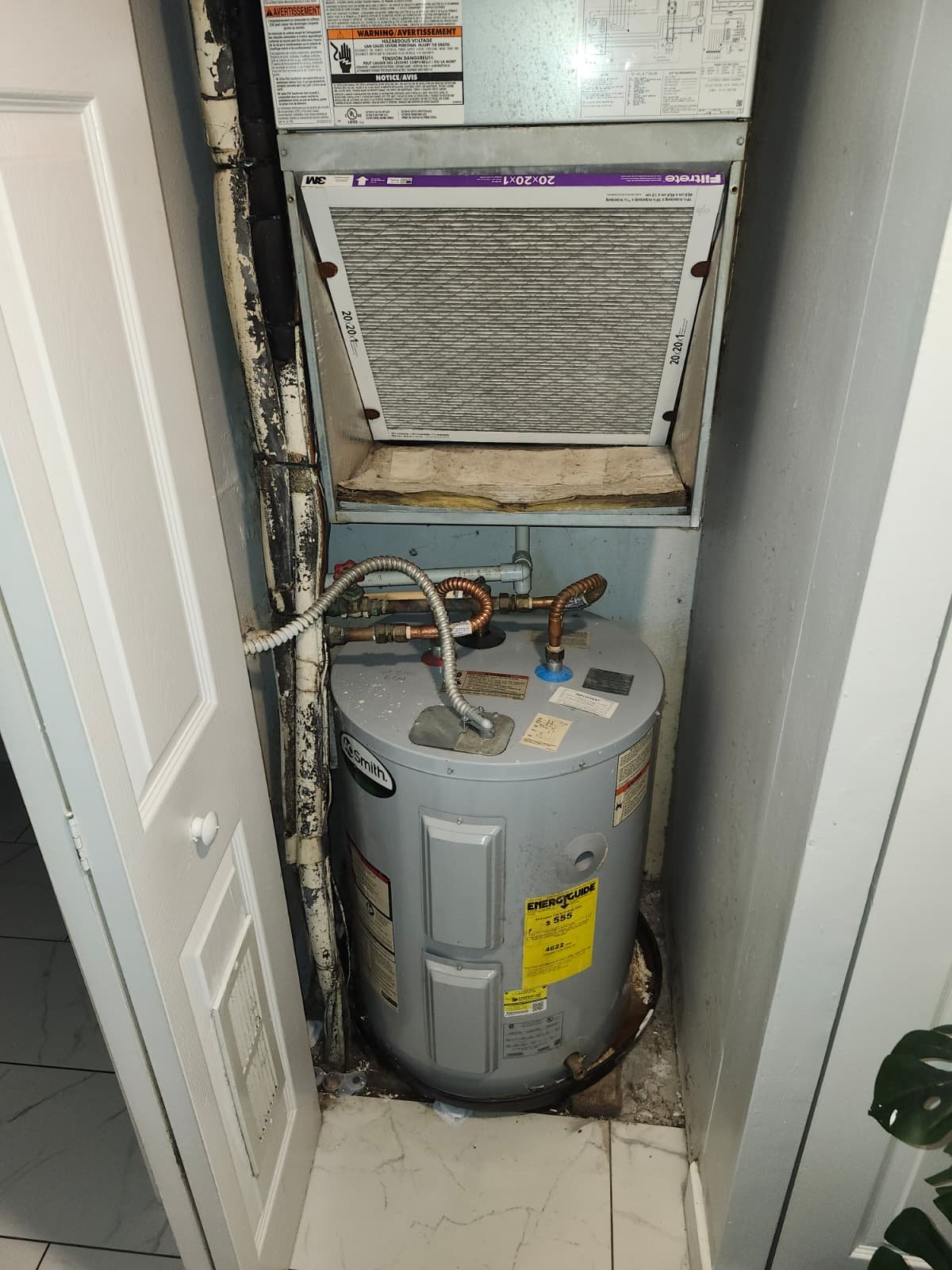 Water heater and air filter setup in a closet, Brandon, FL 33511. Home service.