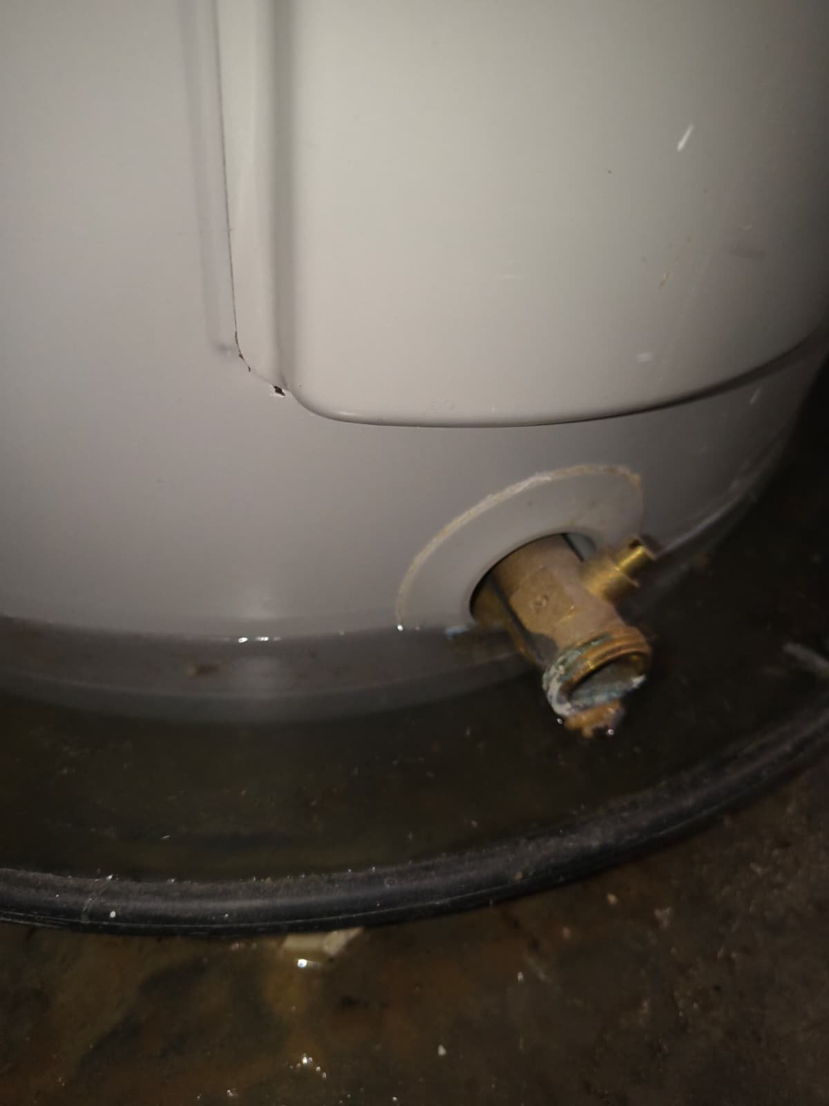 Close-up of water heater drain valve with water on floor, Riverview, FL 33579.