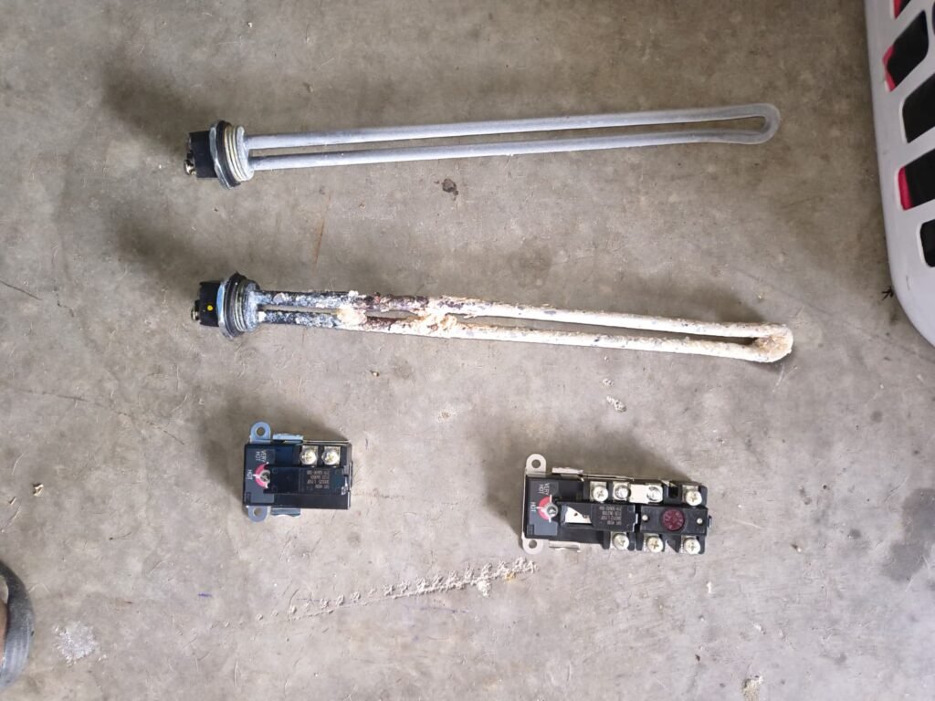 An old and a new water heater element and thermostat side by side in Ruskin, FL 33570.