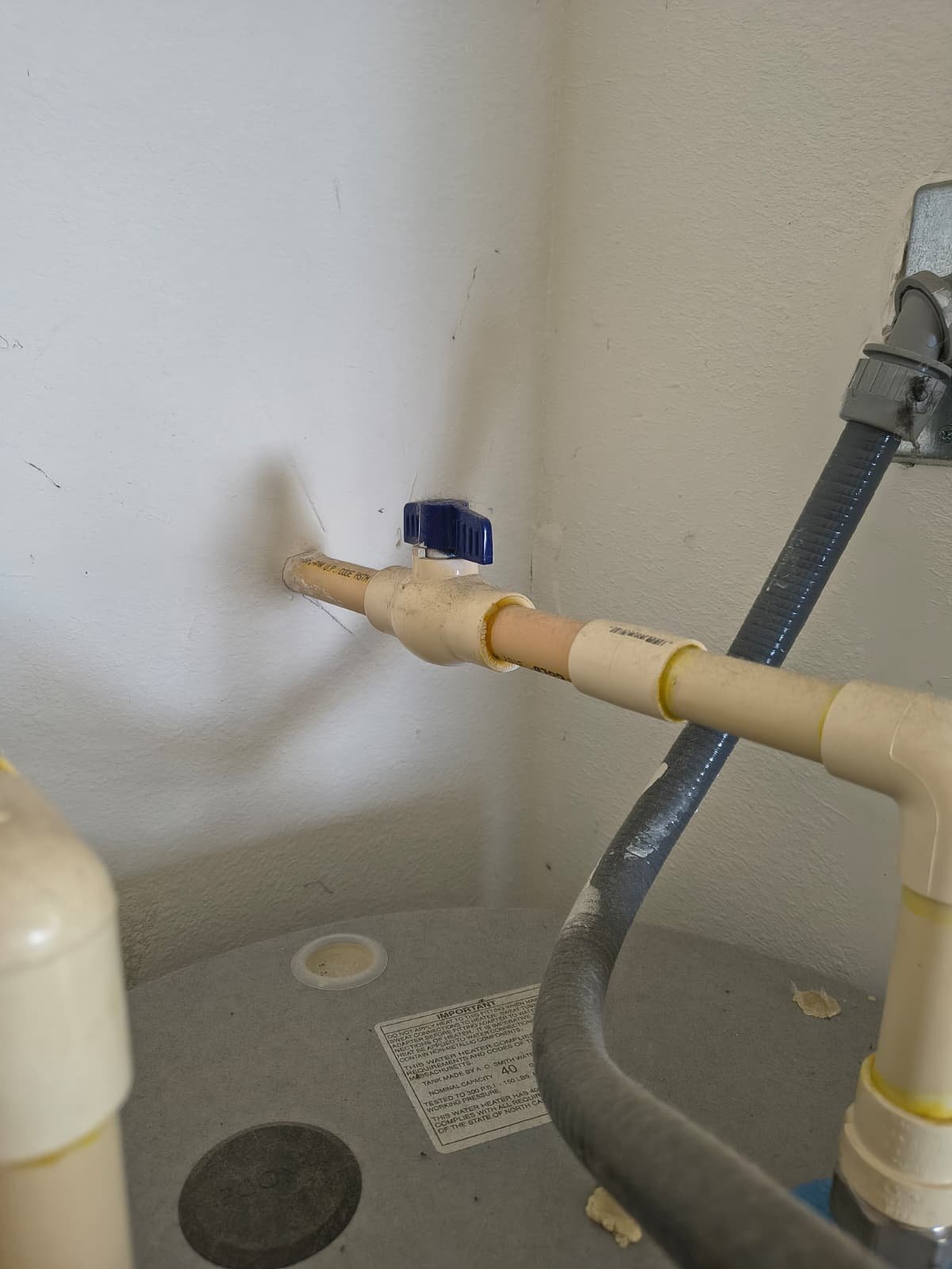 Plumbing connection with valve on water heater during service in Riverview, FL 33569.