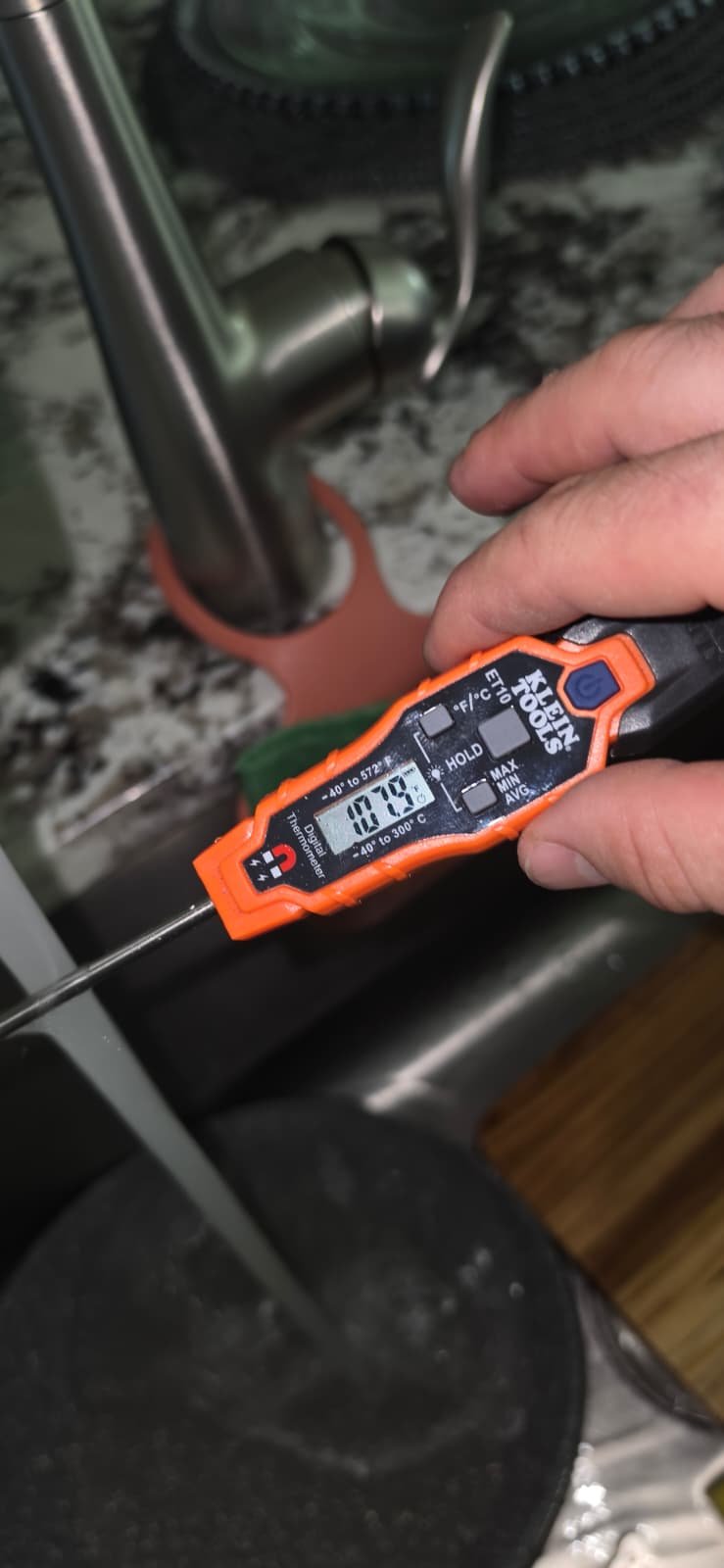 Digital thermometer measuring water temperature in Riverview, FL 33579.