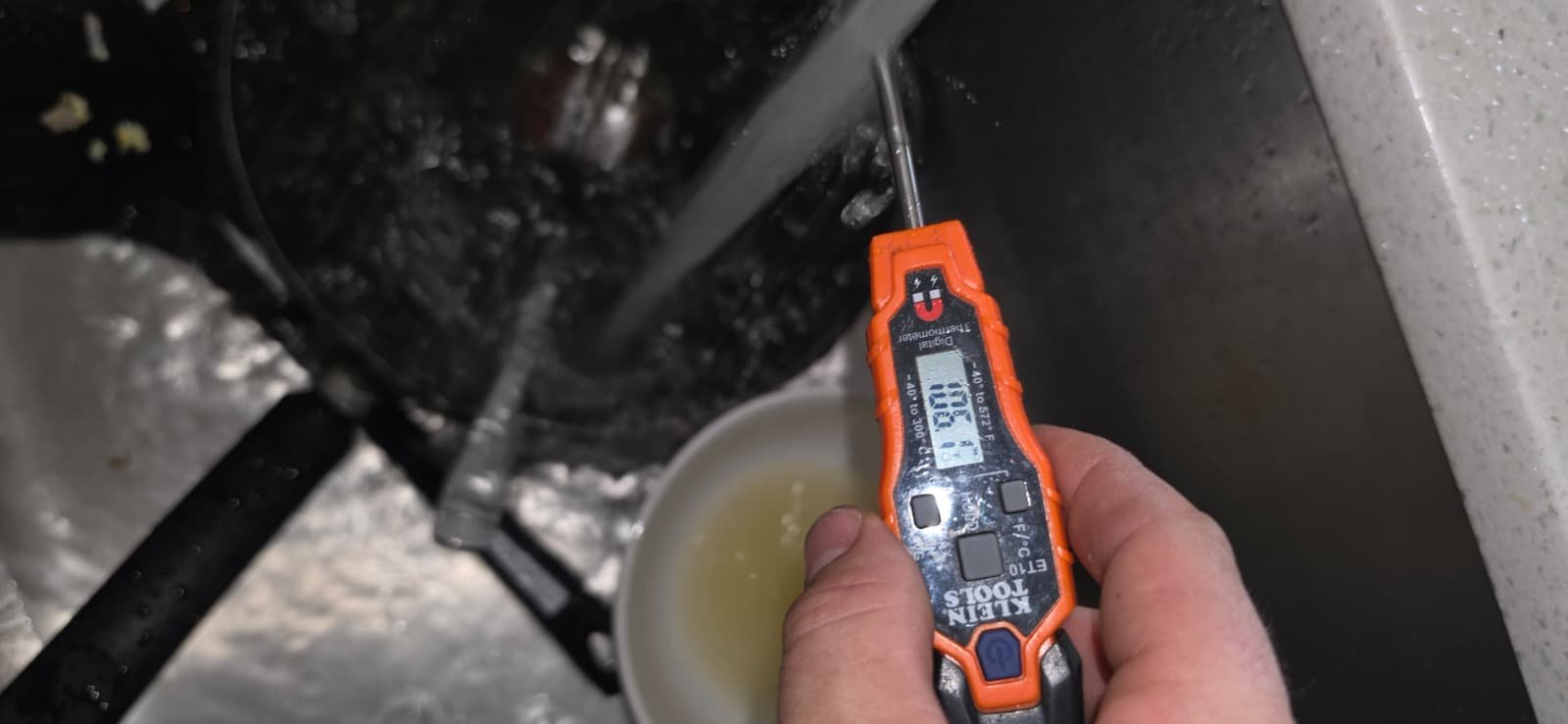 Digital thermometer measuring water temperature in sink, Brandon, FL 33511.