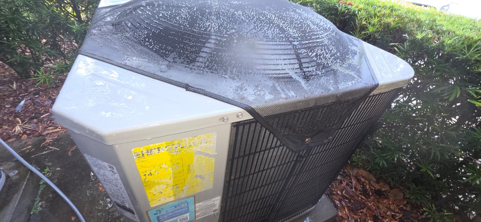 Outdoor AC unit with water spray for cleaning in Lutz, FL 33559.