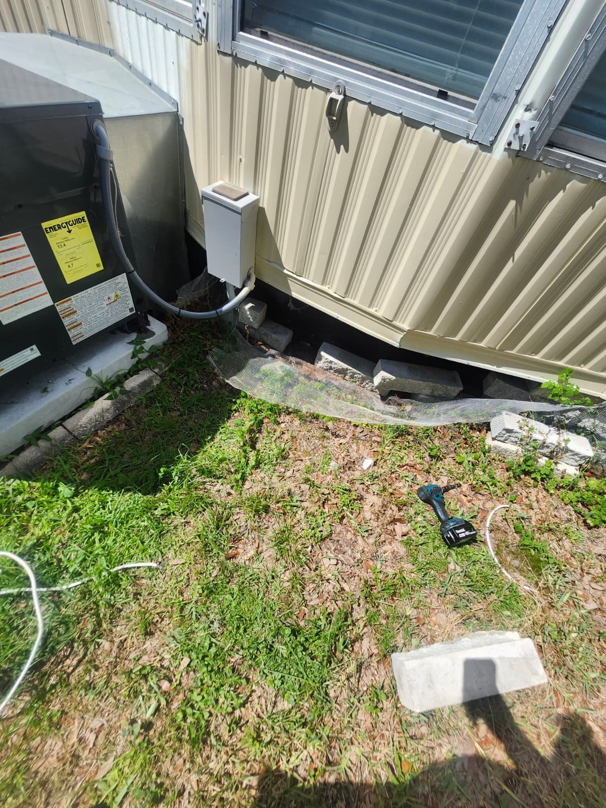 AC unit installation with tools and materials in Odessa, FL 33556. Professional setup.