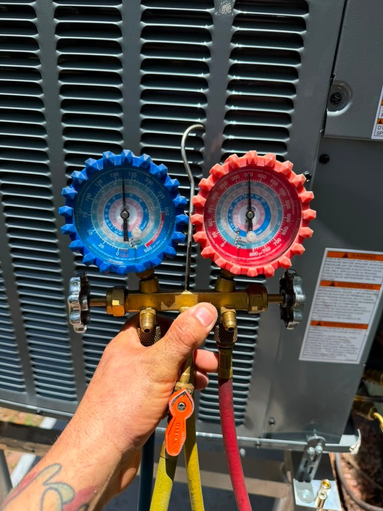 AC Performance Test in Gulfport, FL 33707 Technician testing AC unit performance with gauges in Gulfport, FL 33707.