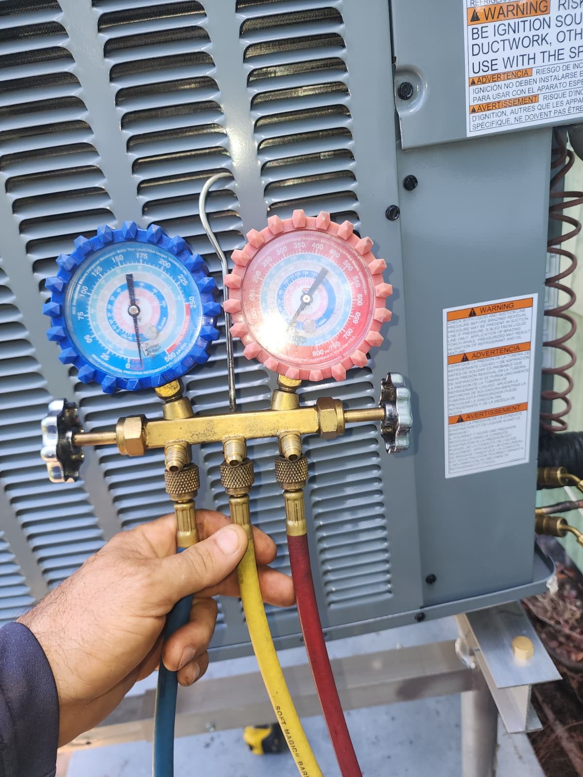AC Pressure Check in Gulfport, FL 33707 Technician checking AC unit pressure with gauges in Gulfport, FL 33707.