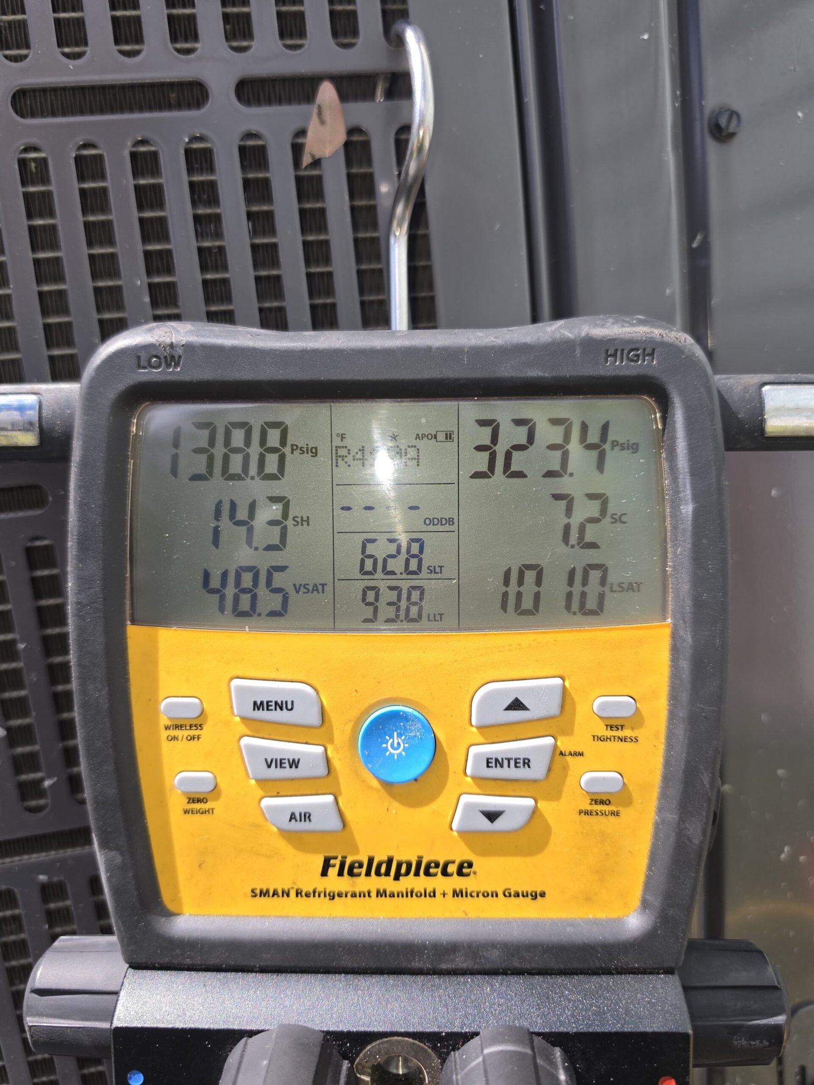 Fieldpiece manifold gauge showing pressure readings for AC service in Tampa, FL 33605.