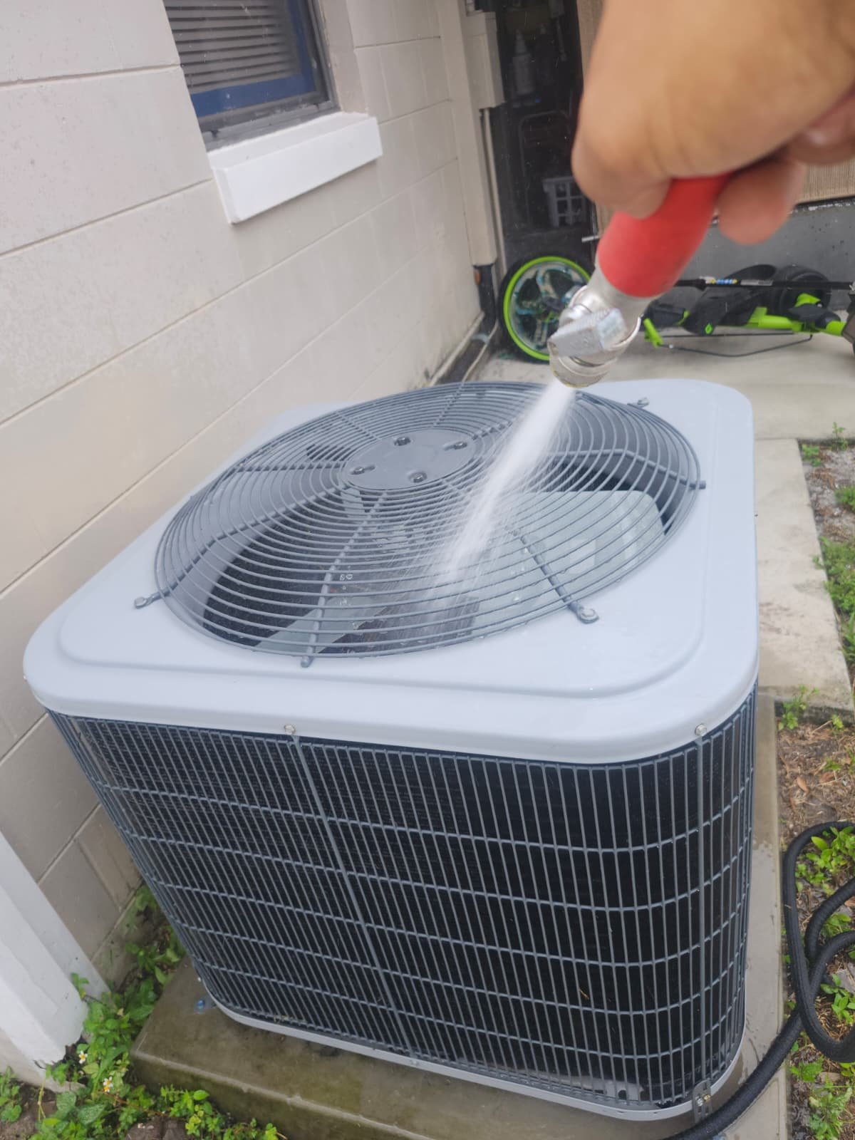 AC Unit Cleaning - Tampa, FL 33614 Outdoor AC unit being cleaned with a hose in Tampa, FL 33614. Part of Premium Therapy Plan.