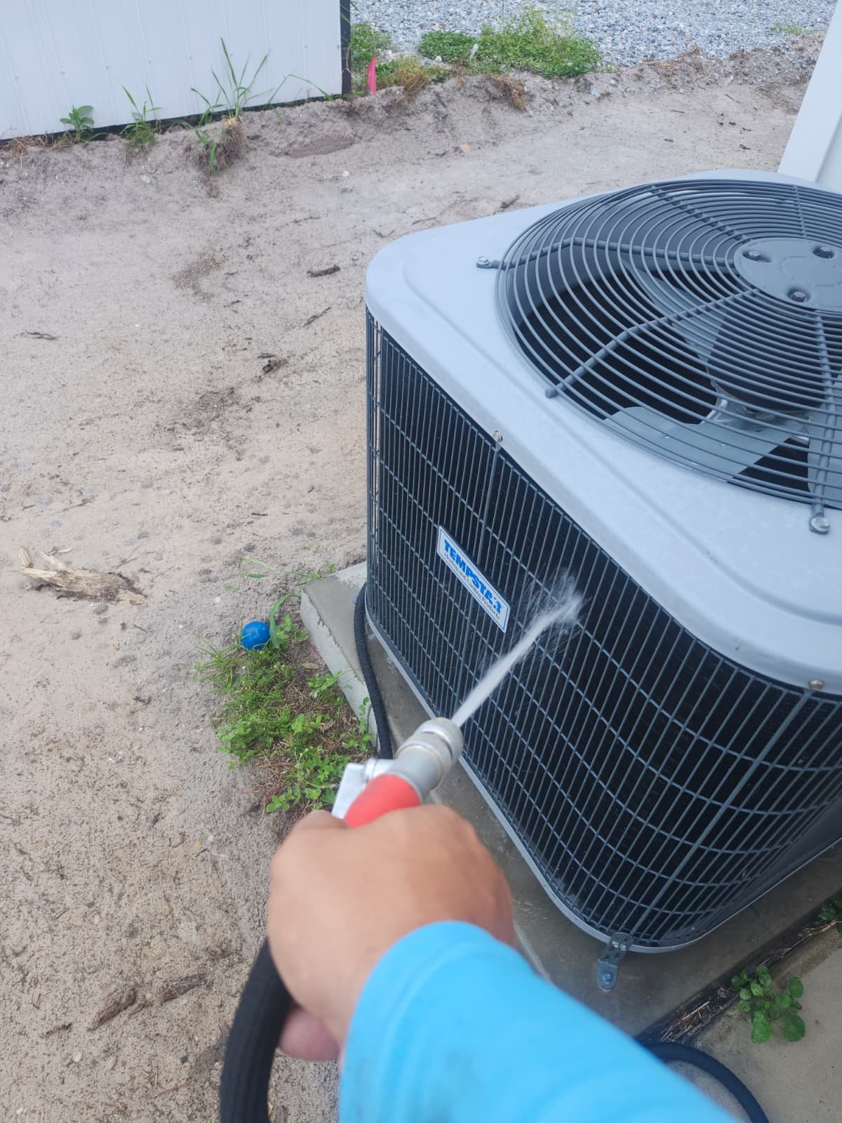AC Unit Cleaning - Tampa, FL 33614 Outdoor AC unit being cleaned with a hose in Tampa, FL 33614. Part of Premium Therapy Plan.