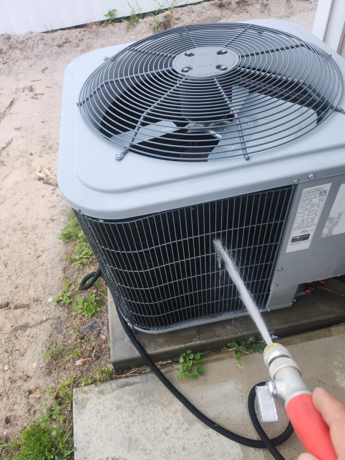 AC Unit Cleaning - Tampa, FL 33614 Outdoor AC unit being cleaned with a hose in Tampa, FL 33614. Part of Premium Therapy Plan.