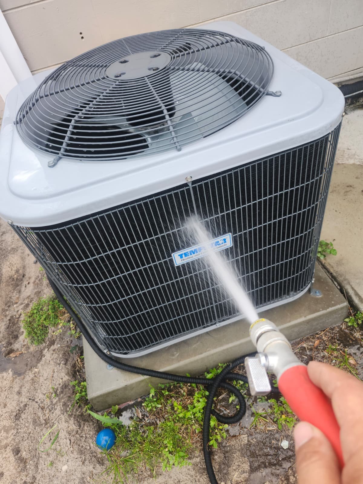AC Unit Cleaning - Tampa, FL 33614 Outdoor AC unit being cleaned with a hose in Tampa, FL 33614. Part of Premium Therapy Plan.