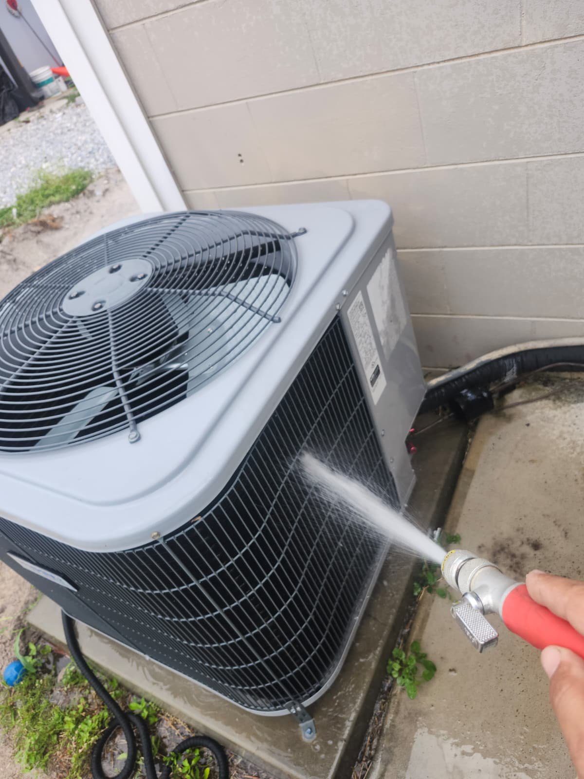 AC Unit Cleaning - Tampa, FL 33614 Outdoor AC unit being cleaned with a hose in Tampa, FL 33614. Part of Premium Therapy Plan.