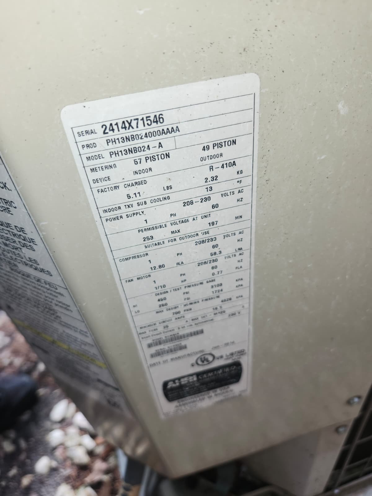 Close-up of AC unit label showing specifications in Tampa, FL 33618.