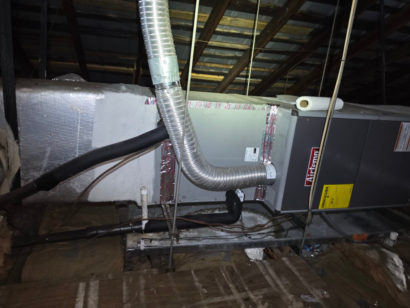 Air handler unit with duct connections in attic for HVAC service in Tampa, FL 33605.