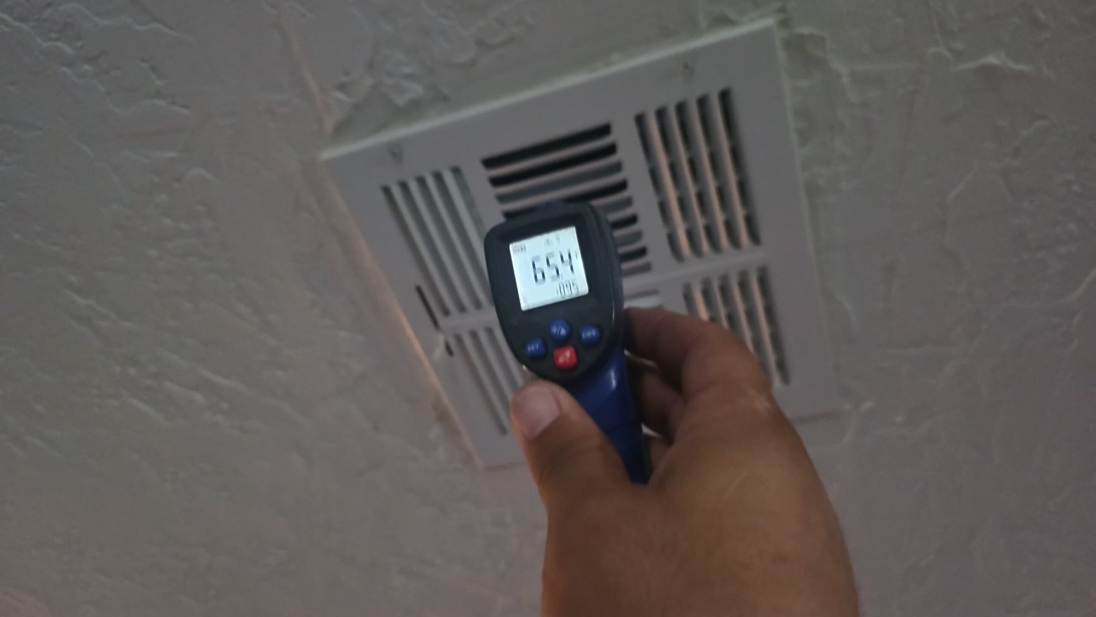 Technician measuring air temperature from vent, Largo, FL 33774.