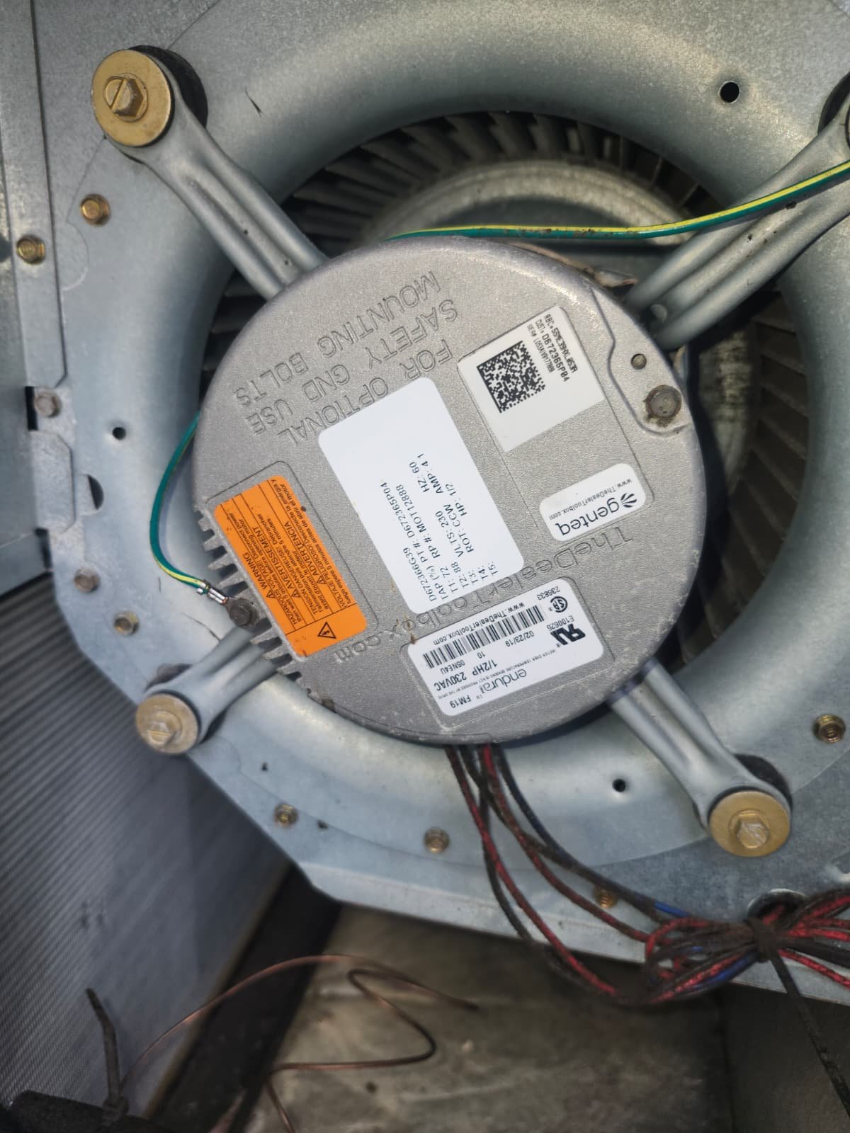 Blower motor installed inside HVAC unit in Tampa, FL 33618. Blower Motor Replacement in progress.
