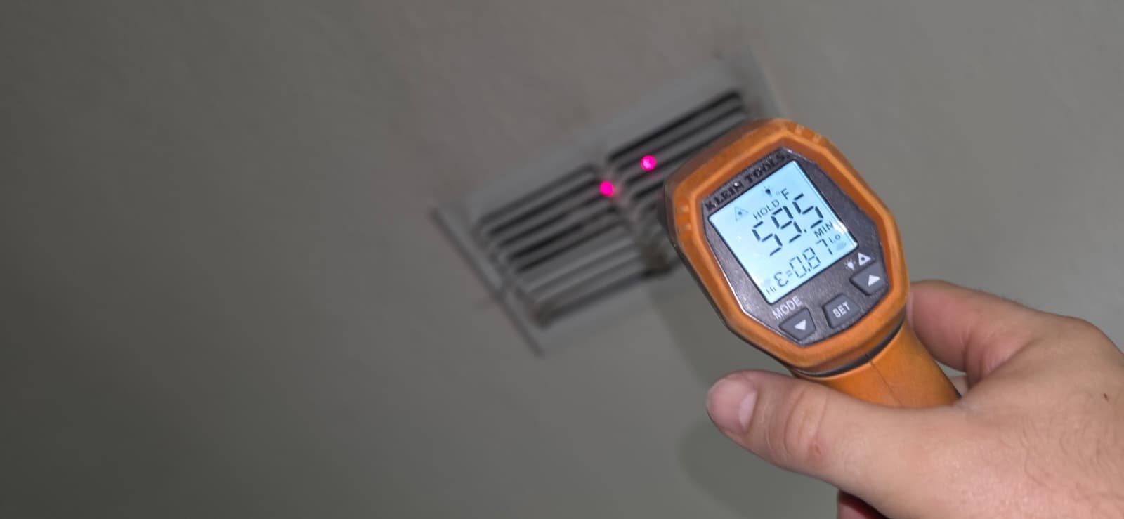 Temperature reading at ceiling vent with laser thermometer in Tampa, FL 33624.
