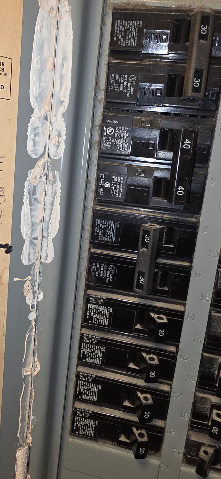 Circuit Breaker Panel in Tampa, FL 33615 Close-up of circuit breaker panel with caulking in Tampa, FL 33615.