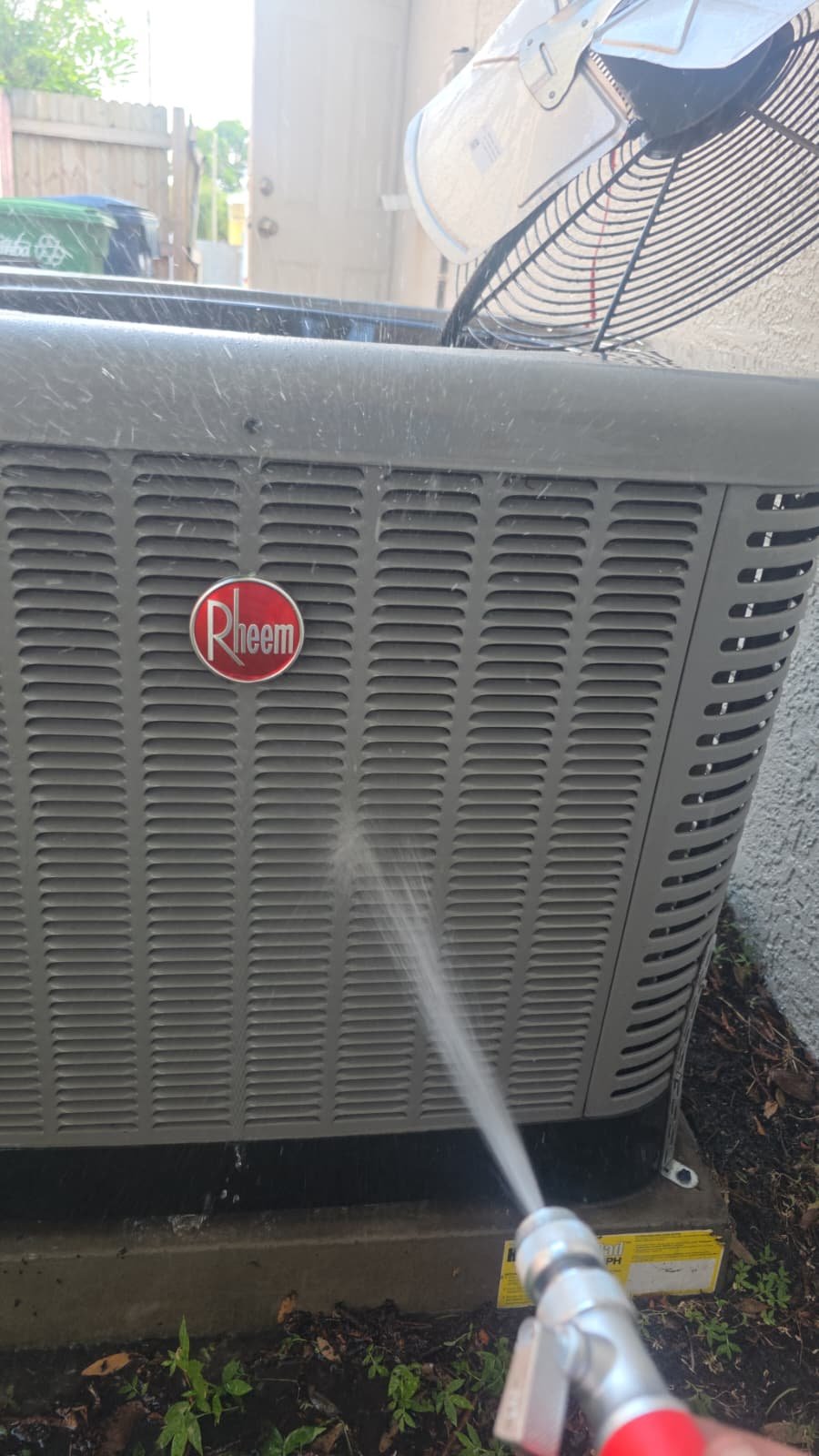 Condenser Unit Exterior Cleaning - Tampa, FL 33607 Water spray cleaning Rheem condenser unit exterior in Tampa, FL 33607.