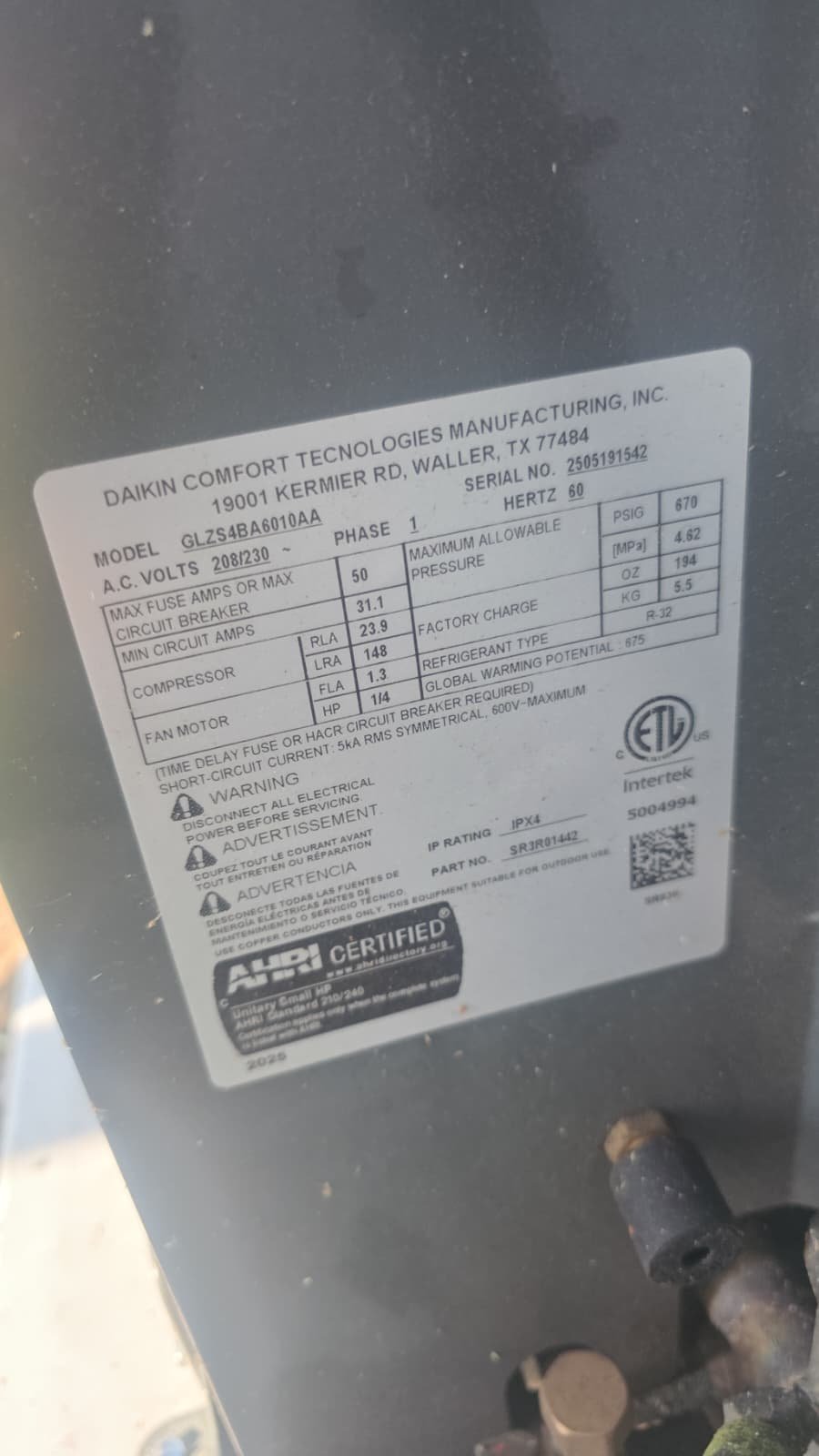 Close-up of Daikin AC unit label showing specifications in Riverview, FL 33579. Detail of AC unit.