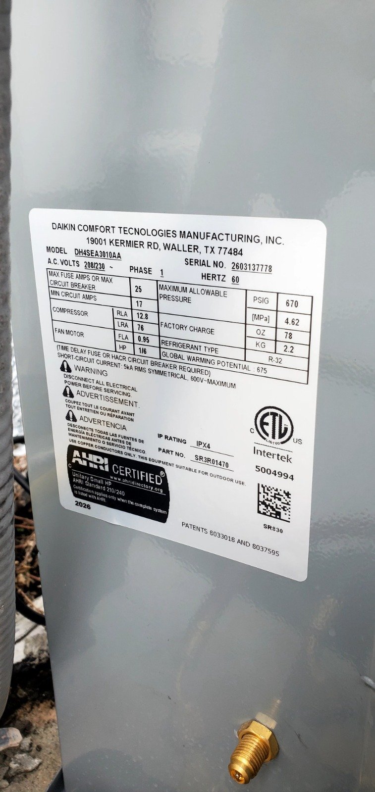 Close-up of Daikin unit label with manufacturing details in Tampa, FL 33616.