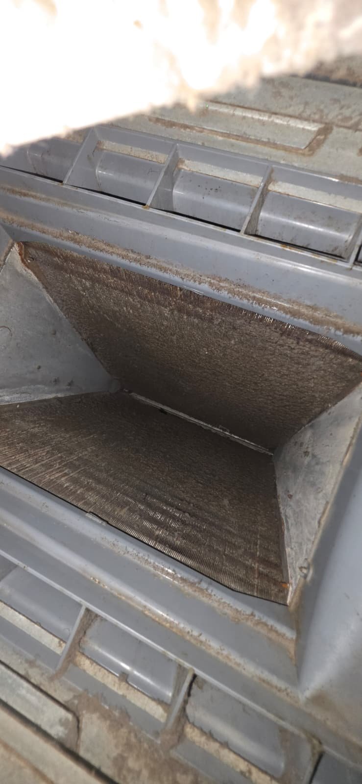 Dirty Air Filter in HVAC System - Tampa, FL 33612 Close-up of dirty air filter in HVAC system for maintenance in Tampa, FL 33612.