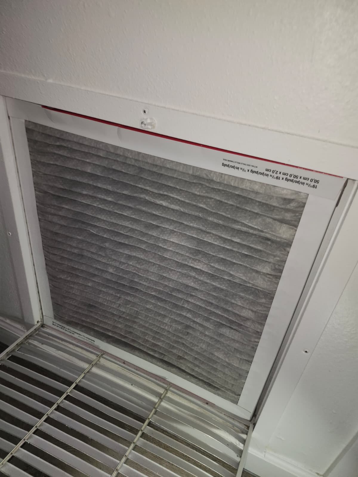 Close-up of dirty air filter in vent in Tampa, FL 33618.